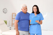 © Pixel-Shot - Female doctor showing something on clipboard to senior patient in medical office
