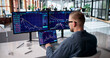 © Andrey Popov - Focused Stock Trader Monitoring Market Trends Across Several