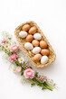© Wallace - op View Easter Eggs in Basket with Spring Flowers on White Background