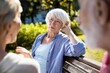 © Prazis Images - Thoughtful Senior Woman Listening to Friends on a Park Bench