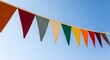 © shamima - Colorful triangular pennant banner hanging against clear blue sky