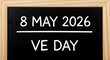© Different Design - 8 May 2026 V E Day written in white chalk on a black chalkboard blackboard date