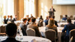 © Rahman - Business conference with speaker presenting to audience in a hotel meeting room