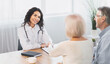 © Prostock-studio - General Practitioner. Mexican woman physician and senior couple patients handshaking at doctor's office, copy space