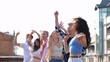 © Vlad - Portrait of many young Caucasian men and women dancing in positive mood and jumping to music outdoors on summer day party. Beautiful cheerful carefree people having fun at party