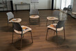 © pressmaster - Empty chairs arranged in circle on wooden floor, each seat holding notebook and brochure, suggesting preparation for therapy session in modern office