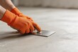© Julie - Person smoothing concrete floor with trowel
