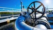 © savittree - Industrial pipeline system with valve against clear blue sky at a water treatment facility