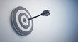 © 3kaaaju - A single black dart perfectly hits the bullseye of a grey and white target board, symbolizing precision and goal achievement.