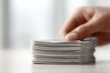 © Chandlerlikes - Person hand organizing a stack of banknotes, neutral tones, professional wealth management