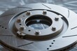 © junrong - Close-up view of a metallic brake disc with ventilation slots and mounting bolts