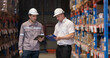 © eakgrungenerd - Warehouse supervisors inspecting inventory, checking stock on tablet and clipboard in distribution center, logistics operation, warehouse management, audit process and supply chain control concept.