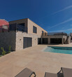 © .shock - Aerial view of a modular modern smart automated house with pool, stone facade and work in progress