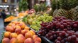 © Aliaksandr - Fresh assorted fruits including apples, grapes, pineapples, and oranges displayed in vibrant market setting with blurred background of shoppers and stalls