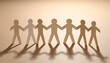 © kartu - A group of cutout paper people holding hands