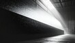 © Azke - Vue en noir et blanc d'un faisceau lumineux perçant le toit d'une usine désaffectée créant un contraste dramatique avec les ombres denses du hangar.