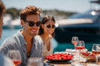 © lublubachka - Friends enjoy lunch on a boat with fresh fruit and drinks by the water on a sunny day