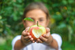 © yanadjan - The child eats an apple in the garden. Selective focus.