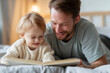 © maria_lh - Happy father and cute toddler reading a book together on a bed. Smiling dad and child relaxing in a bedroom. Family bonding and early education concept