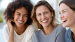 © Nataliya - Diverse women friends laughing together enjoying a candid moment, female friendship and positive lifestyle concept, defocused background, with copy space