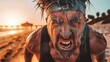 © StasySin - Man screams intensely on beach at sunset. Sweat and sand cover his face and body. He wears headband, showing raw emotion and struggle. Ideal for sports, fitness, or motivational themes