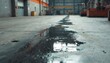© Viktor - Water and oil pool on concrete floor in industrial area. Dark liquid reflects light in a manufacturing plant. Maintenance and cleaning needed for hazardous floor.