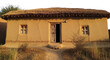 © Ramzano - Traditional mud house with thatched roof, rustic clay cottage in rural village, ancient earthen architecture with wooden door and windows isolated PNG with Transparent Background