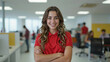 © Creuxnoir - Woman in a red shirt smiles confidently at the camera.