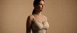 © ArNeoS - Young woman in beige lingerie posing against a neutral background, fashion lifestyle, feminine elegance, body wellness