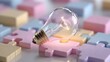 © possawat - Light Bulb on Puzzle Pieces in Soft Pastel Colors Displaying Ideas