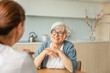 © Юлия Завалишина - Female doctor examining older senior woman in doctor office or at home. Old woman lady patient and doctor have consultation in hospital room. Medicine healthcare medical checkup. Visit to doctor