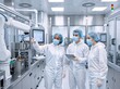 © Vasiliy - Diverse team of engineers in cleanroom suits inspecting a robotic arm. Scientists working with automated machinery in a modern manufacturing facility. High tech production
