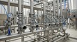 © Nazlykhan - Stainless steel pipe system in brewery. Industrial equipment with pressure gauge and control panel at beverage production facility. Pipeline engineering for sanitary fluid processing.