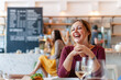 © Rawpixel.com - Joyful woman in cozy cafe