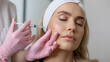© Visi Vox Unit - Aesthetic facial injection for skin rejuvenation, professional cosmetic procedure with dermal fillers or botox. Young woman receiving anti-aging treatment at beauty clinic with medical syringe