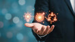 © ViskBx - Businessman holding virtual icons of light bulb, target, and team connection representing innovation, goal setting, and networking