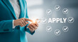 © Lily - Businesswoman applying online, checkmarks and apply button on screen