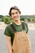 © Devka - A handsome young asian man wearing a casual outfit outdoors, standing and leaning against his car