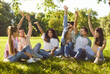 © Studio Romantic - Diverse group of friends, people sitting together in circle, green sunny outdoor park, interacting, relaxed sociable team, enjoying happy time outdoors in green grassy park, engaged in conversation