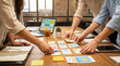 © Jonathan - Creative team collaborates on visual content strategy, arranging summer-themed cards for a new digital project launch.