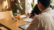 © Christine - Professional photograph of two colleagues discussing business documents and a tablet during a collaborative meeting.