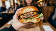 © lucio valentine - Delicious beef burger with melted cheese and fresh lettuce in natural light