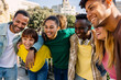 © Xavier Lorenzo - Happy diverse group of millennial students and best friends enjoying time together outdoors on a sunny day, laughing and bonding at the city street. Youth, friendship, and positive lifestyle concept.