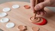 © Volha - Mixing foundation makeup on a wooden palette, creating custom color for beauty and cosmetics application