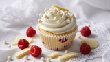 Delicious raspberry cupcake with creamy white frosting and decorative chocolate pearls on 