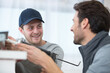 © auremar - two male contractors using silicone during kitchen installation