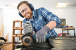© auremar - man using angle grinder on car bodywork