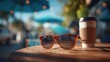 © Joyce - Spring Summer outdoor leisure relaxation activity. A vivid, sunlit outdoor scene features a pair of tortoiseshellframed sunglasses resting on a wooden surface. To the right of the sunglasses.