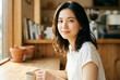 © maaagram - コーヒーを飲みながらリラックスする笑顔の日本人女性 ライフスタイル Generative AI