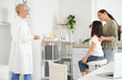 © Pixel-Shot - Female pediatrician checking little girl's eyesight and mother in clinic